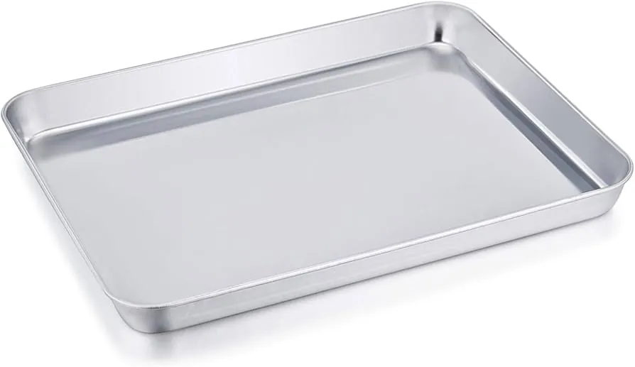 Cleaning supplies for a toaster oven lined up on a kitchen counter
