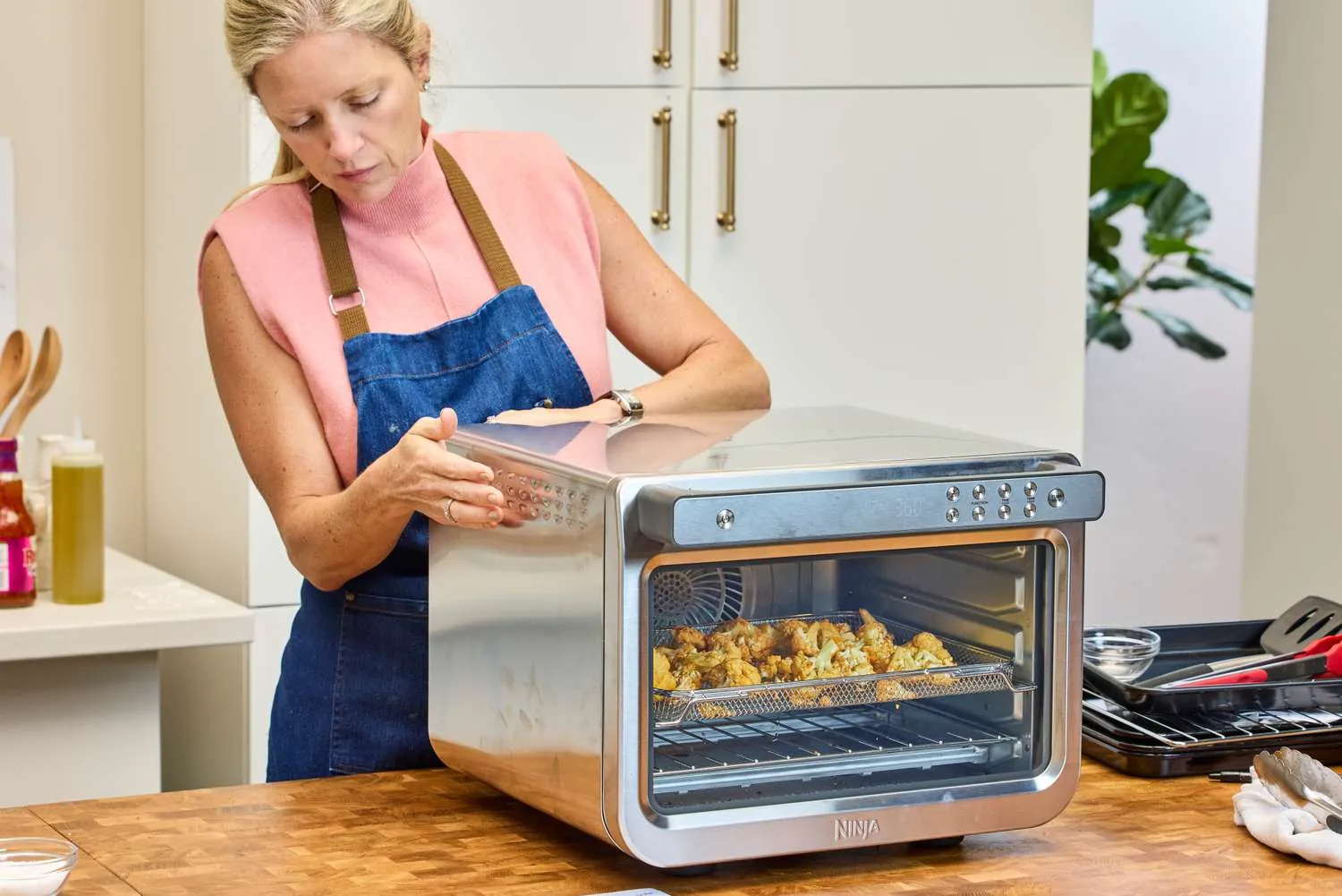 Convection fan and heating element inside an air fryer toaster oven