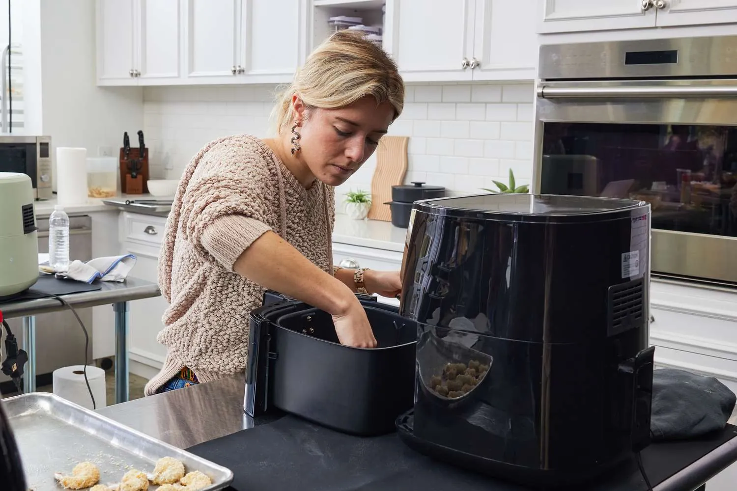 Small air fryer with basket out beside calendar and notebook