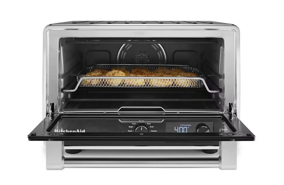 Soggy uneven chicken pieces clumped on one side of an air fryer oven rack